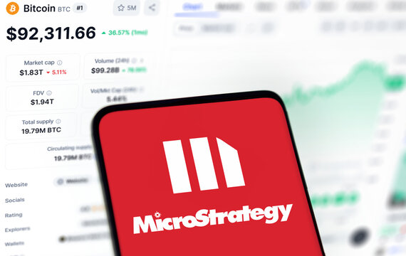 Dhaka, Bangladesh- 27 nov 2024: microstrategy logo is displayed on smartphone and Bitcoin price on the background.