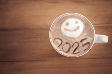 hot coffee with foam milk art 2025 on wooden table