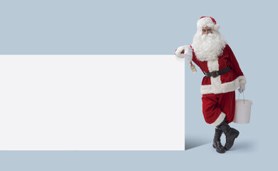 Creative Santa Claus with paintbrush and blank sign