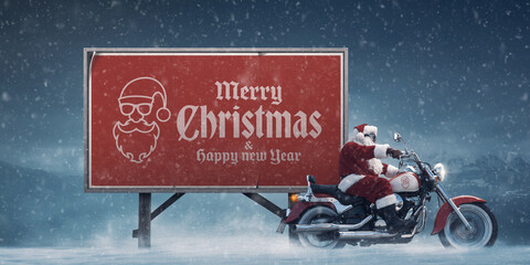 Cool biker Santa Claus and Christmas wishes on a billboard