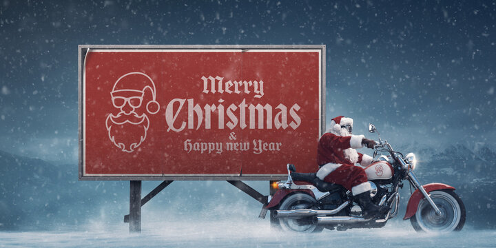 Cool biker Santa Claus and Christmas wishes on a billboard