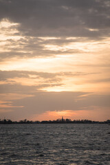 Sunset at Langweerder Wielen (Frisian: Langwarder Wielen), Frisian Lake in the Netherlands. View of the church tower of Langweer. 
