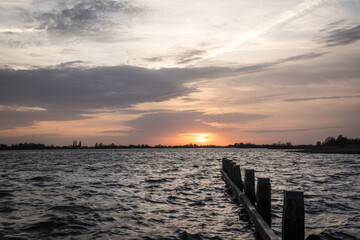 Sunset at Langweerder Wielen (Frisian: Langwarder Wielen), Frisian Lake in the Netherlands. View of the church tower of Langweer. 