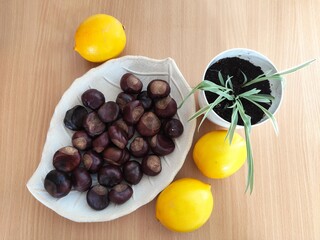 Yellow lemons and shiny brown chestnuts on the table