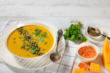 Pumpkin Red Lentil Soup in white bowl, top view