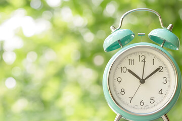 Vintage alarm clock outdoor garden timekeeping device natural setting close-up concept of time management