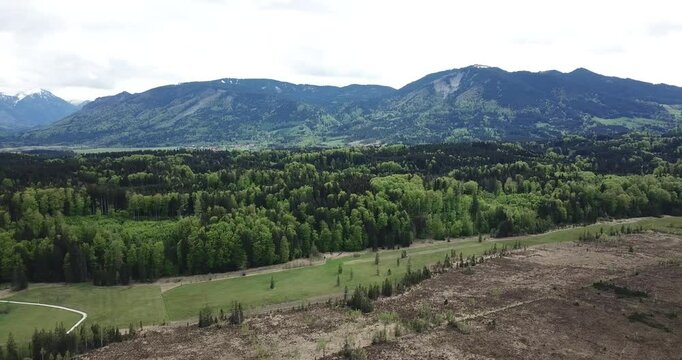 Aerial view, drone flight over a forest and Alps in the background at Staffelsee in Bayern, Germany