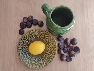Yellow lemons and shiny brown chestnuts on the table