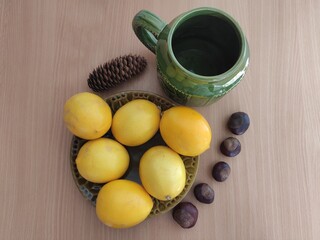 Yellow lemons and shiny brown chestnuts on the table
