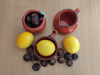 Yellow lemons and shiny brown chestnuts on the table