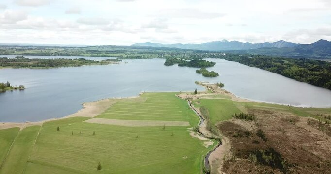Aerial view, drone flight over a forest and Alps in the background at Staffelsee in Bayern, Germany