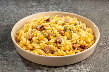 Plate of pasta salad on the table. Macaroni salad.