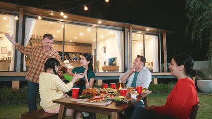 Family together celebrate anniversary in garden. Senior give gift to granddaughter. Outdoor camping activity to relax with relatives, spend time with multigeneration cross generation gap. Divergence.