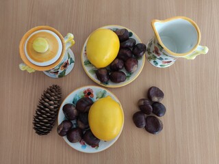 Yellow lemons and shiny brown chestnuts on the table