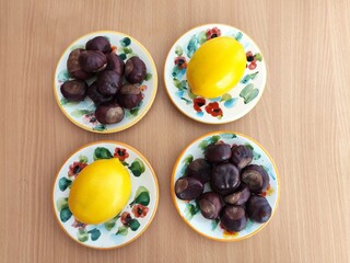Yellow lemons and shiny brown chestnuts on the table