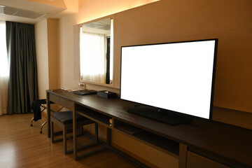 An interior hotel desk setup with an empty screen of television, large mirror, and minimalist decor emphasizes functionality, perfect for stay or relaxation