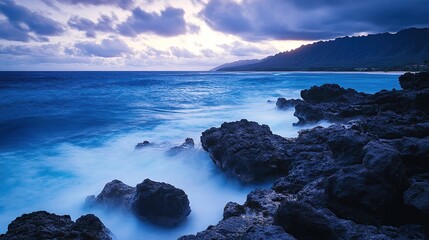 Obraz premium Serene coastal landscape with rocky shore and tranquil ocean waves.