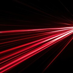 Fototapeta premium A dynamic burst of red light against a dark background.