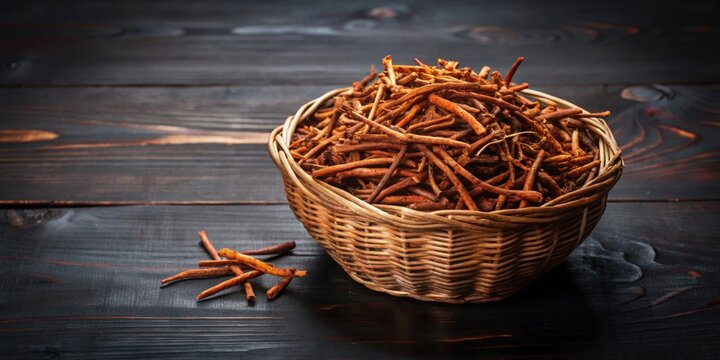 Indian madderwort or madder root in a brown basket on a black wooden surface , Indian madderwort, madder root