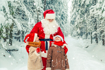 Santa Claus with children in a snowy forest.