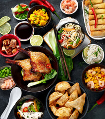 Assorted Chinese dishes and snacks on dark gray background. Traditional food concept.