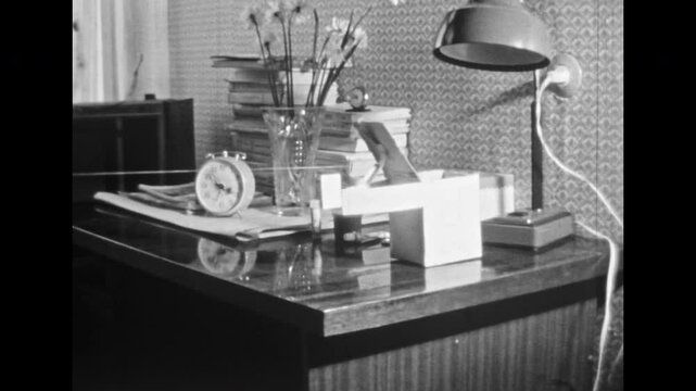 Animated, little aliens arrive on flying ship. Surreal funny humanoid puppet animation. Stop motion extraterrestrial life in apartment background. Vintage black white film. Retro 1980s archive