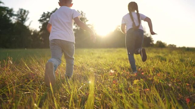 Children running on the grass in summer. Happy family kid dream concept. A family of children running in a park. Family of children running on grass in the park in summer lifestyle.