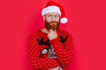 pondering xmas man in santa hat. merry xmas. bearded santa man on xmas holiday isolated on red