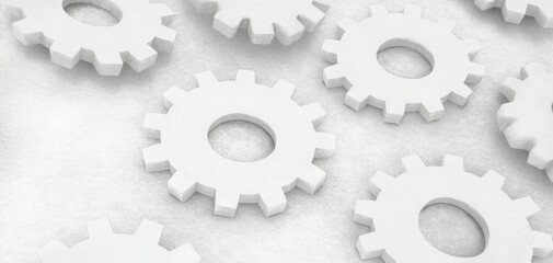 A clean layout of white gears arranged on a light surface, symbolizing mechanics, precision, and engineering.
