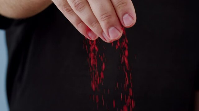 Professional chef adds paprika fragrant dry peppers to a pot of boiling food. Restaurant kitchen cooking, colorful spices, dropping spices.