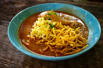 Thai Chicken Curry Noodle Soup with crispy noodles Khao Soi. Traditional Thai cuisine.