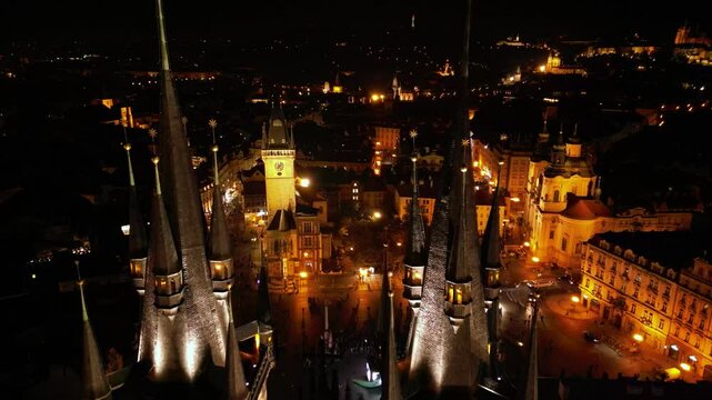 Aerial night footage of the old city center of Prague, Czech Republic. Bohemia capital Praha seen from above. Old town square, the Prague Astronomical Clock and Tyn Church seen in the evening light.
