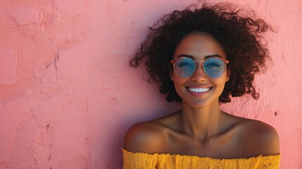 Portrait of a smiling woman wearing stylish sunglasses against a vibrant pink textured wall, exuding a cheerful and confident aura on a sunny day