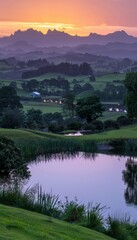 Fototapeta premium Serene mountain lake at sunrise reflecting the beautiful pink and purple sky overhead