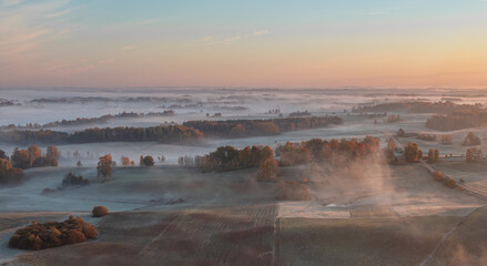 Golden morning with a veil of mist. Autumn landscape in the countryside of Latgale. Latvian nature.

