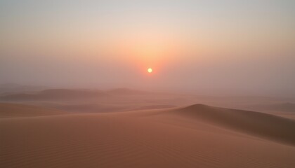 Obraz premium Misty desert sunrise with soft light illuminating sand dunes.