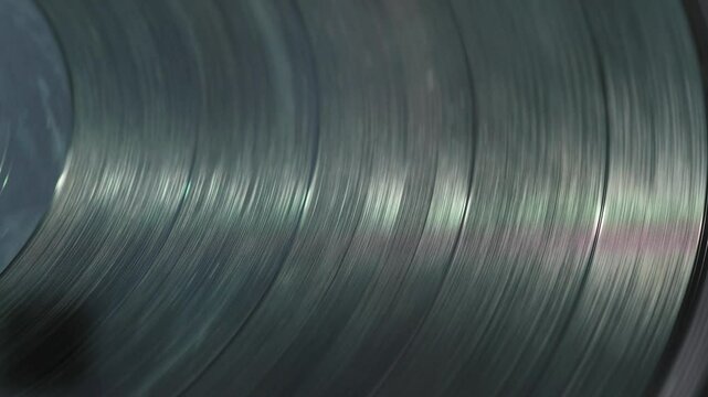 black spinning vinyl record in turntable, retro vinyl disc plays music on record players or gramophone
