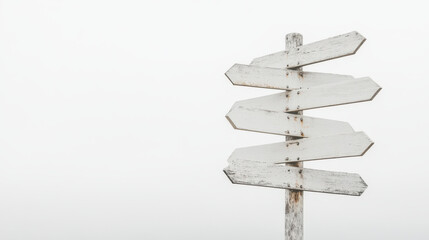Minimalist white signpost with multiple empty signs against foggy background