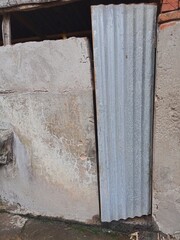 Simple bathroom building of people in the village with a zinc door