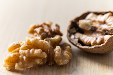 Shelled walnuts, kernels next to in-shell walnuts and nutcrackers. Production, consumption of walnuts, nutrition and properties of walnuts.