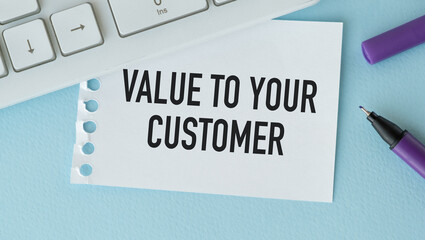 VALUE TO YOUR CUSTOMERS, text on white paper on blue background. business concept