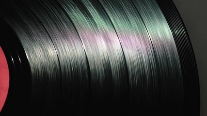 black spinning vinyl record in turntable, retro vinyl disc plays music on record players or gramophone