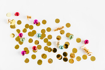 Christmas composition. Christmas colorful balls with golden confetti on the white background. Flat lay top view copy space.