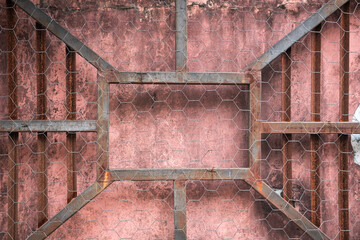 A weathered metal grid with distinct rust marks, the symmetrical pattern evokes an industrial rhythm, symbolizing the passage of time and the fragility of structures