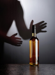 Bottle of white wine on a black table.