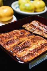 Close up of traditional or local Japanese food - grilled Unagi over rice serve with miso soup, fruit and vegetable. roasted eel cookery. freshness and delicious Japan meals. Juicy food.