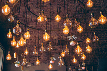 A captivating view of numerous Edison bulbs hanging from a ceiling in Moscow, illuminating the...
