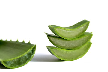 Several pieces of aloe leaves lie on a white background.