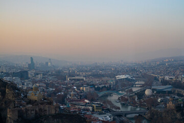 A tranquil winter evening envelops Tbilisi, as soft hues blanket the city skyline.