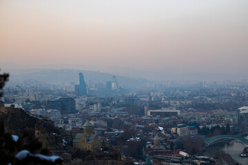 Soft winter light casts a dreamy glow over Tbilisi, highlighting the city's blend of history and modernity.